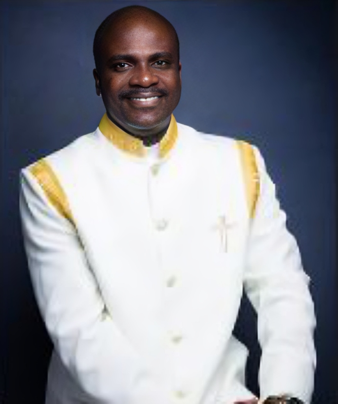 A man is wearing a white jacket with a cross on it.