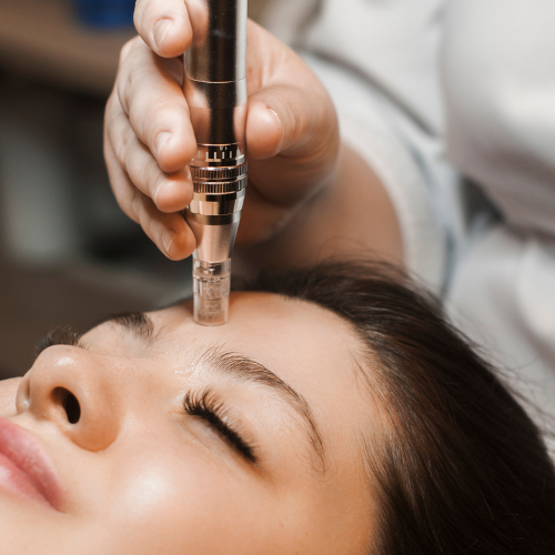 A woman is getting a treatment on her forehead