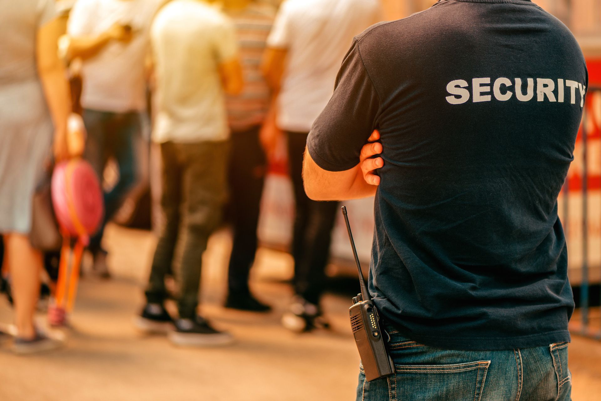 Security services guard monitoring crowd control.