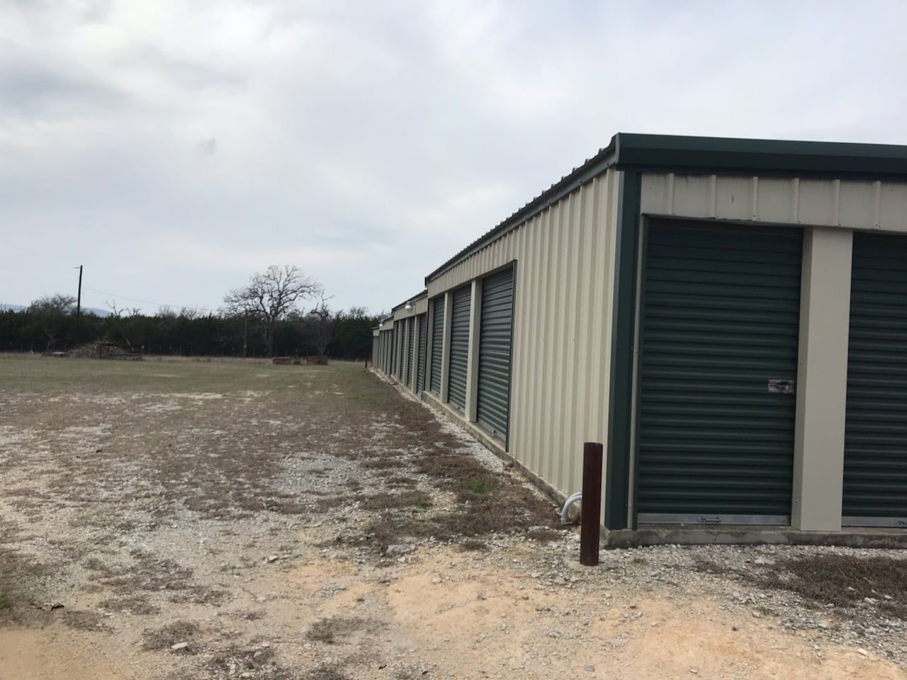 An empty storage room with a concrete floor and metal walls.