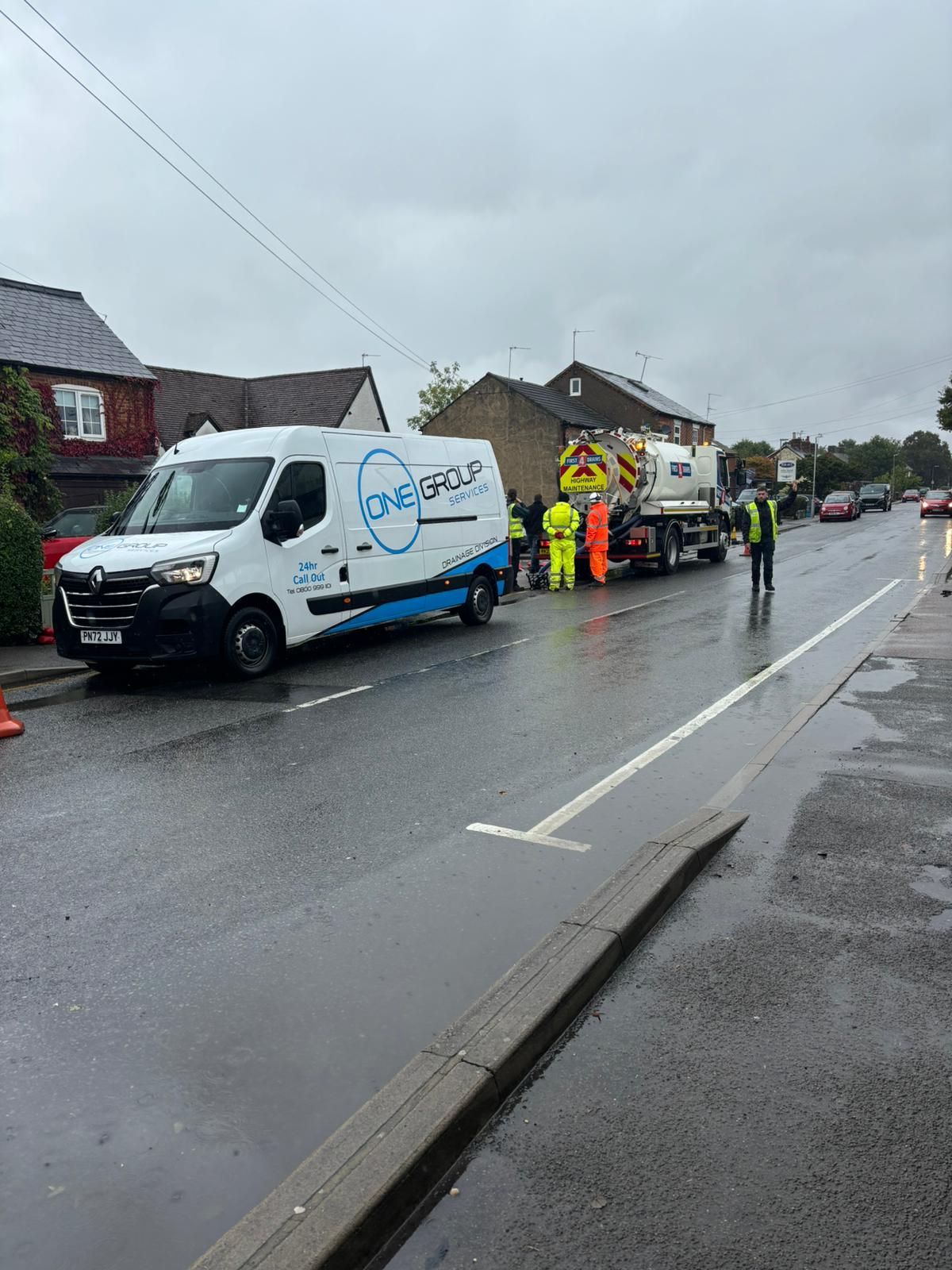 A white van is parked on the side of the road.