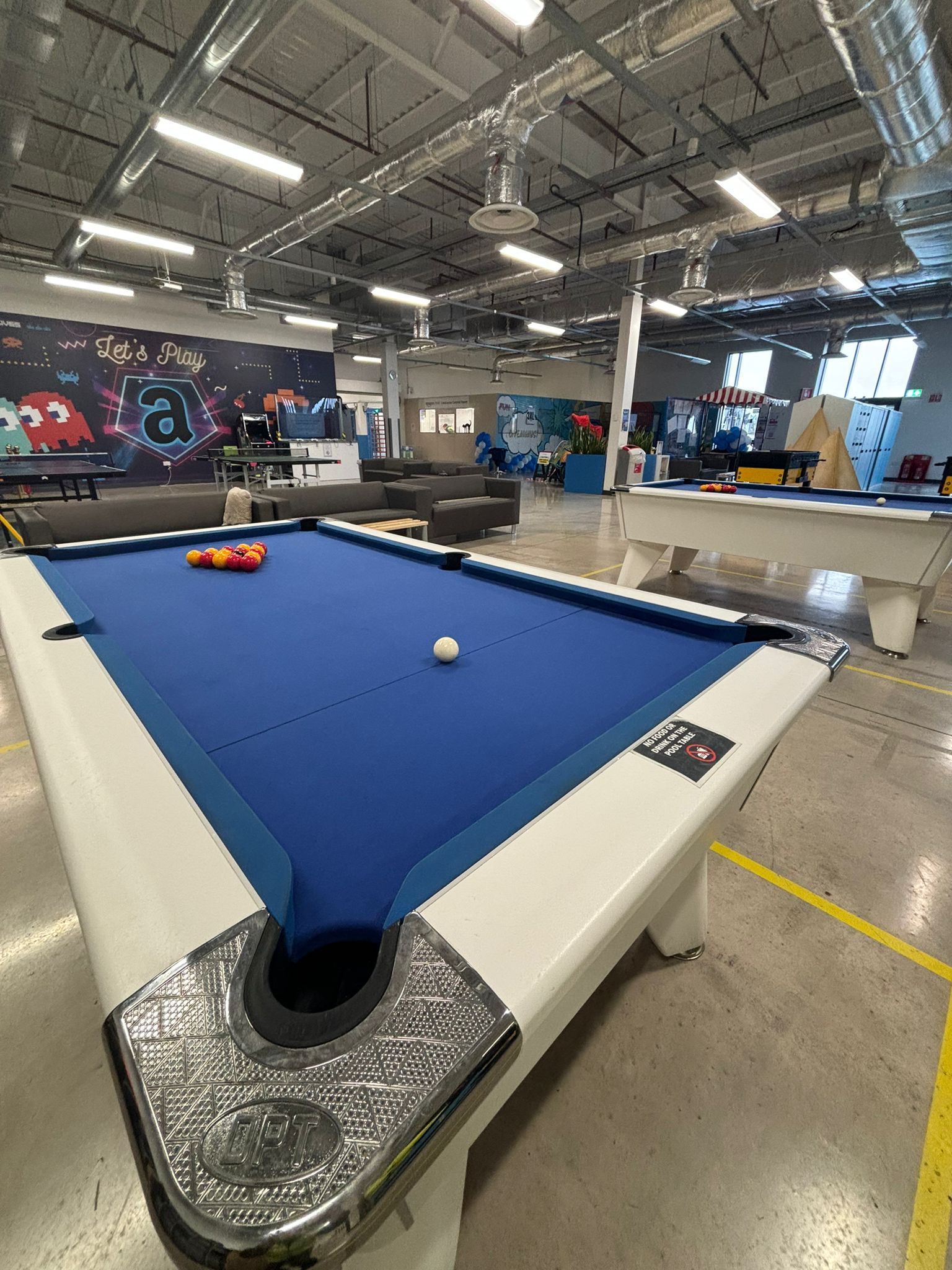 There is a pool table in the middle of the room.