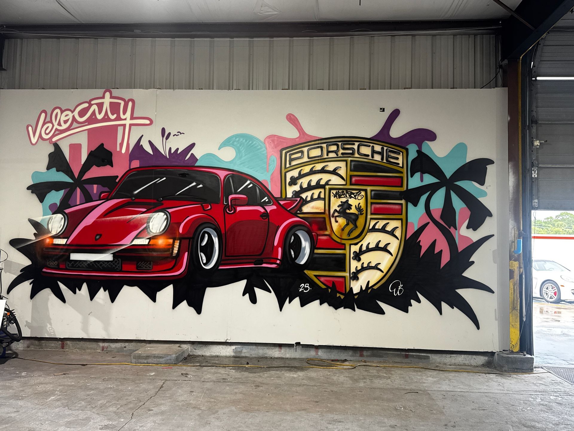 Mural of a red Porsche car and logo, with 