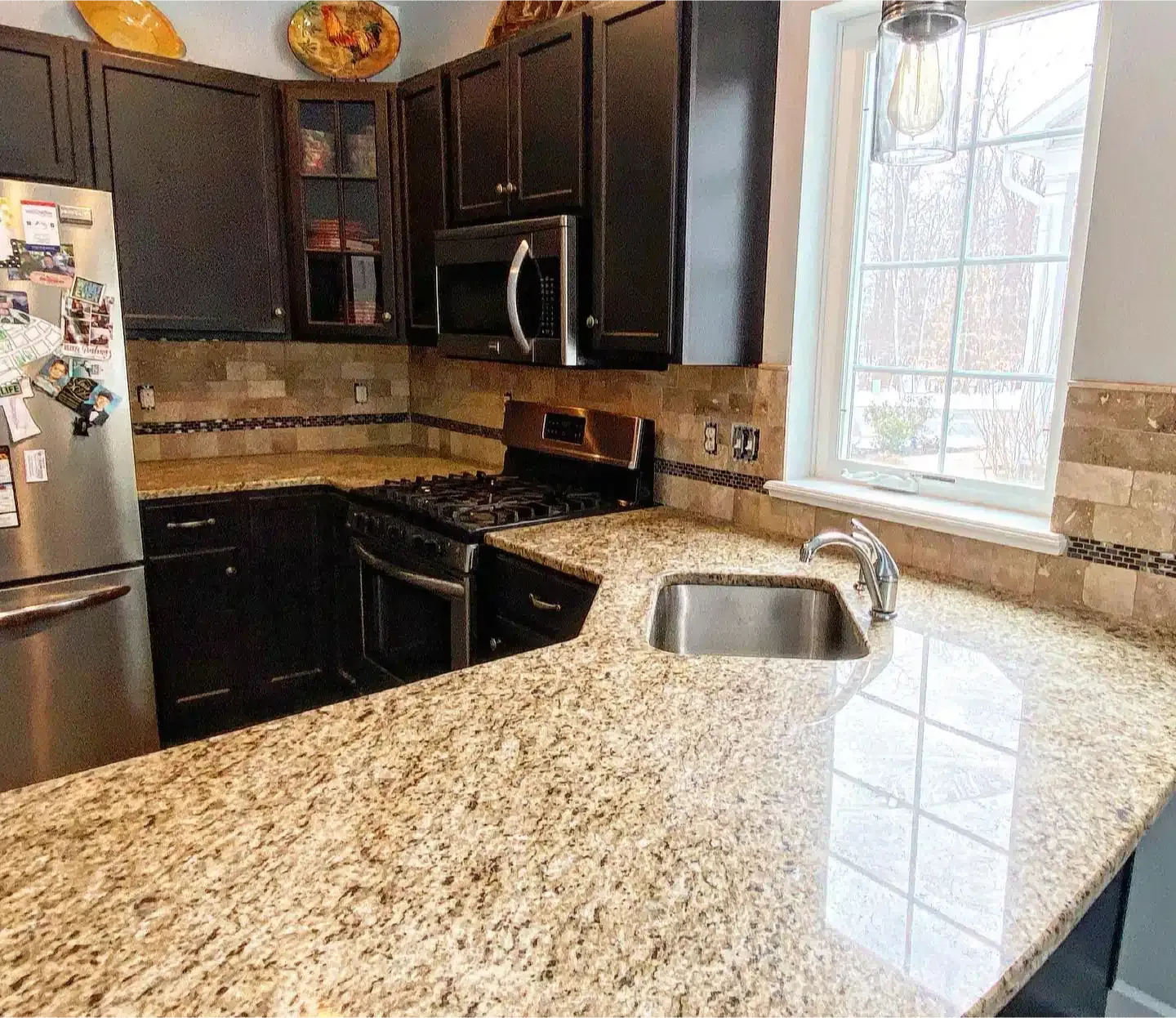 A kitchen with granite counter tops and stainless steel appliances