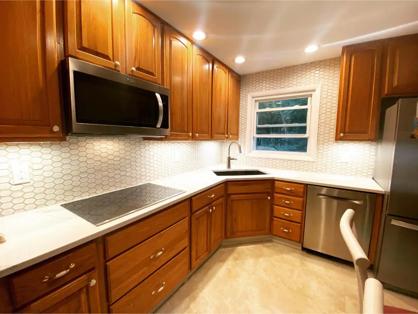A kitchen with wooden cabinets and stainless steel appliances