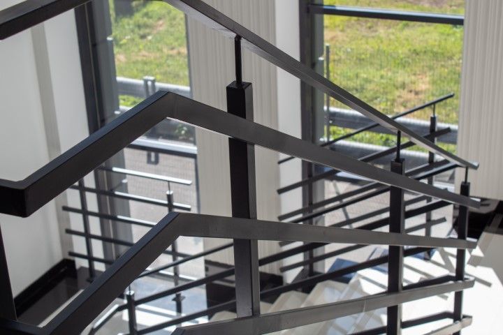 Black metal railing lining office stairs