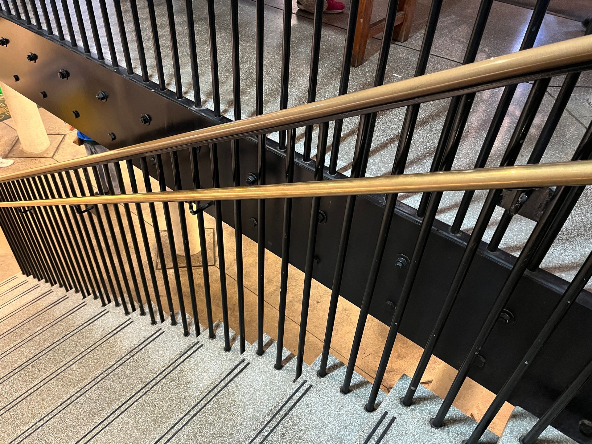 metal handrail along contemporary interior stairs