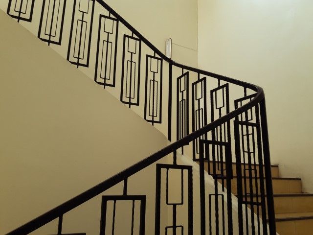 Modern spiral stairs with black iron railings