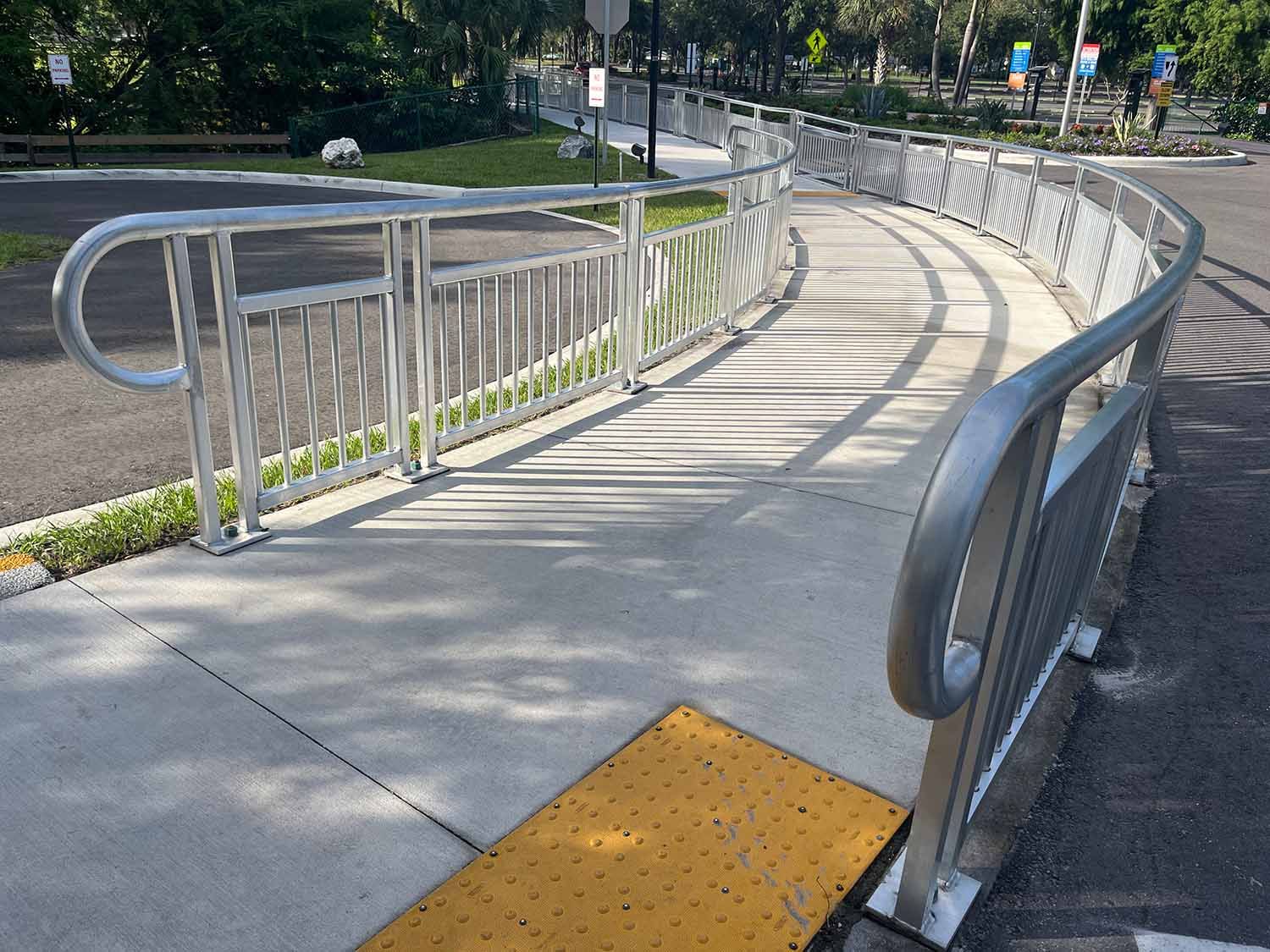 pipe railing along entry sidewalk of parking lot