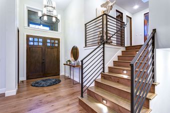 metal horizontal railing in home with stair lights