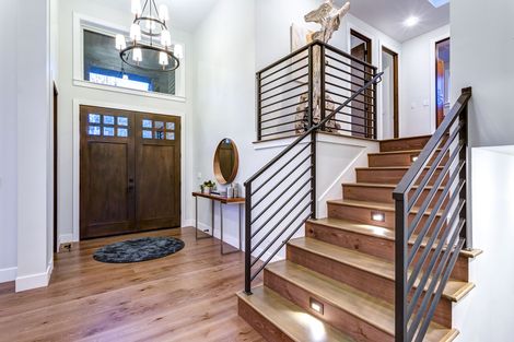 beautiful home with metal horizontal railing on stairs with lights
