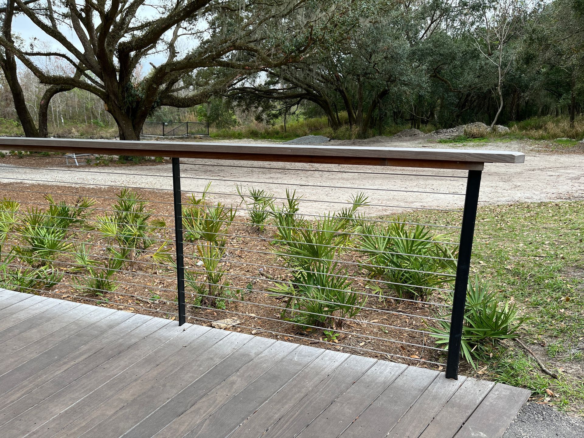 cable railing mounted on wood deck next to yard