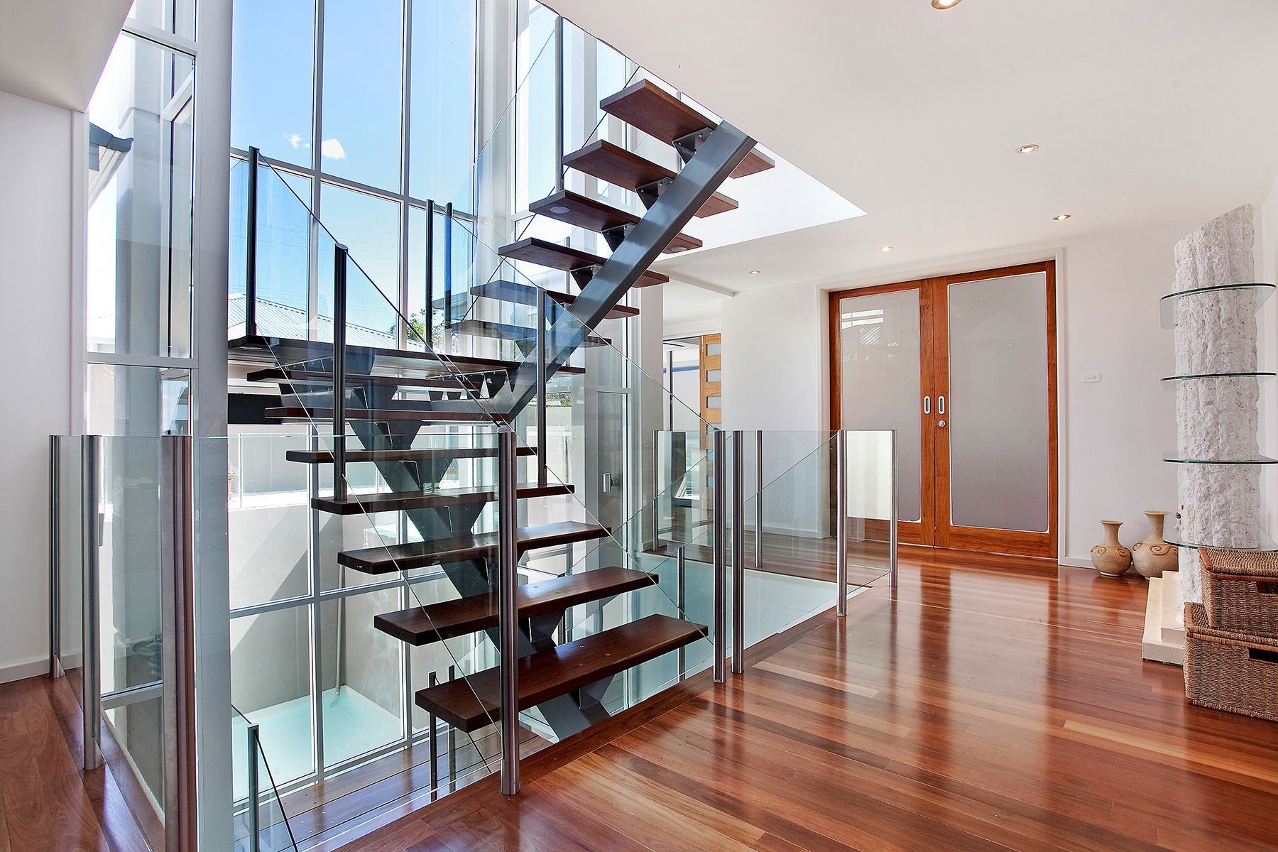 floating stairs Orlando home with hardwood using metal mono stringer