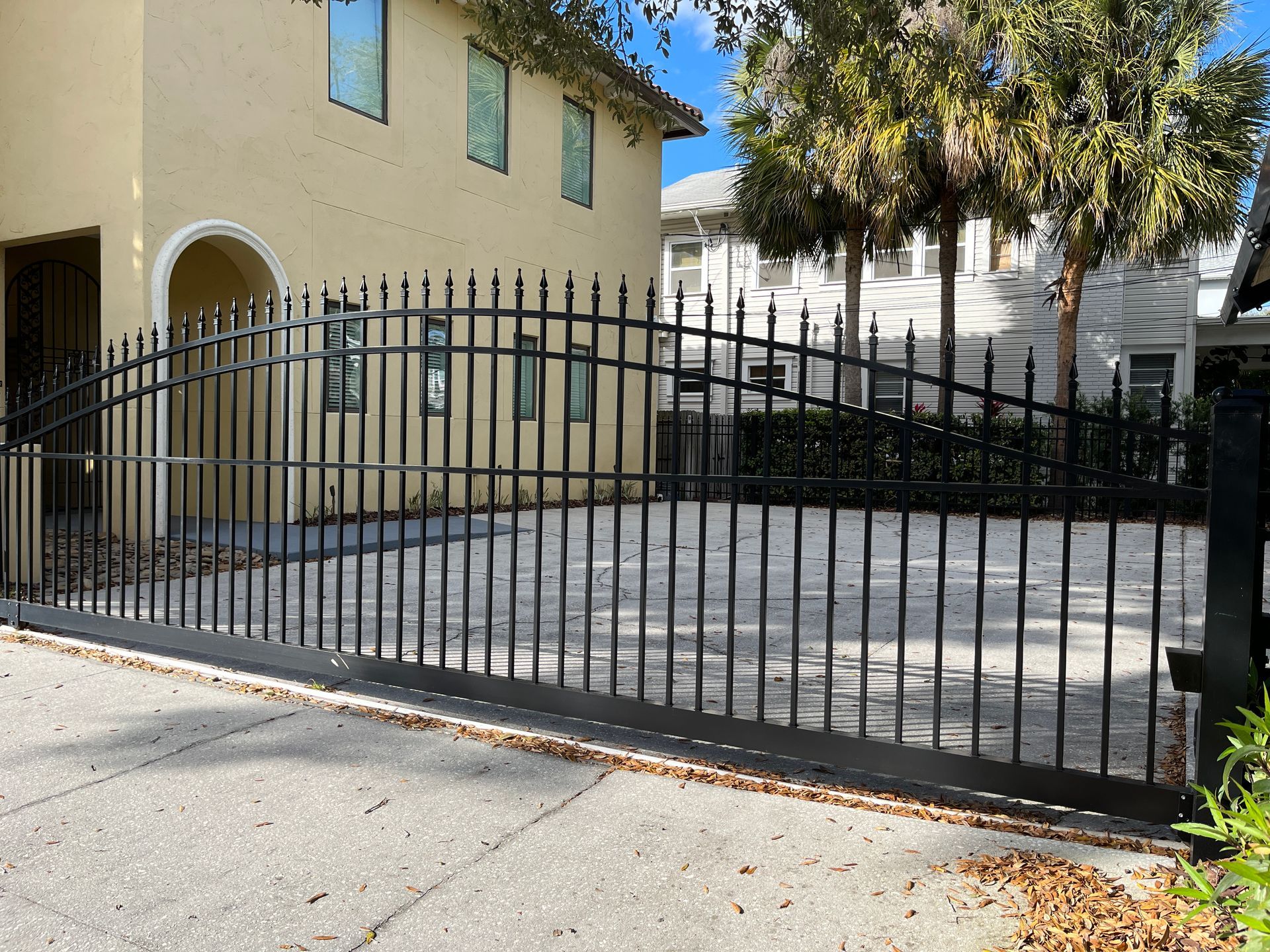 low arching commercial driveway gate for parking lot
