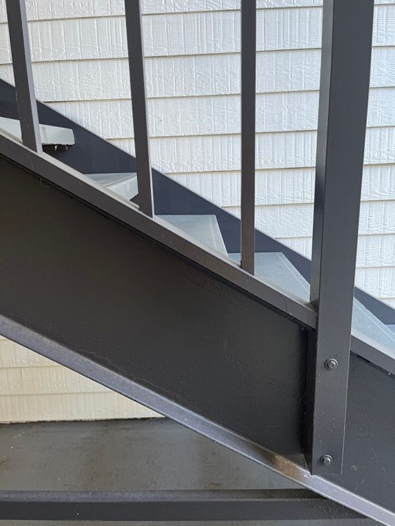 aluminum stair railing, steel stringer and concrete stairs at apartment building