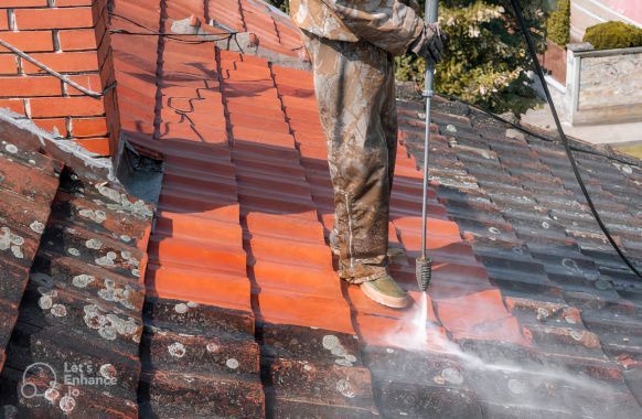 An image showcasing a professional team of women gutter cleaners at work on a UK home. The team, composed of four women from diverse ethnic background