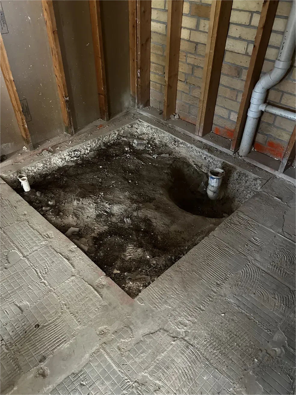 There is a hole in the floor in the middle of the room.