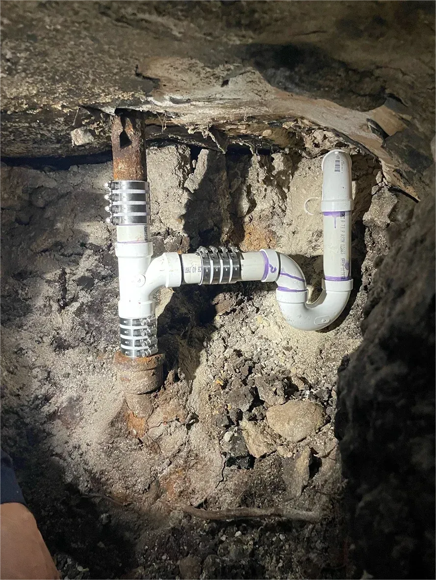 A pipe is being installed in a hole in the ground.