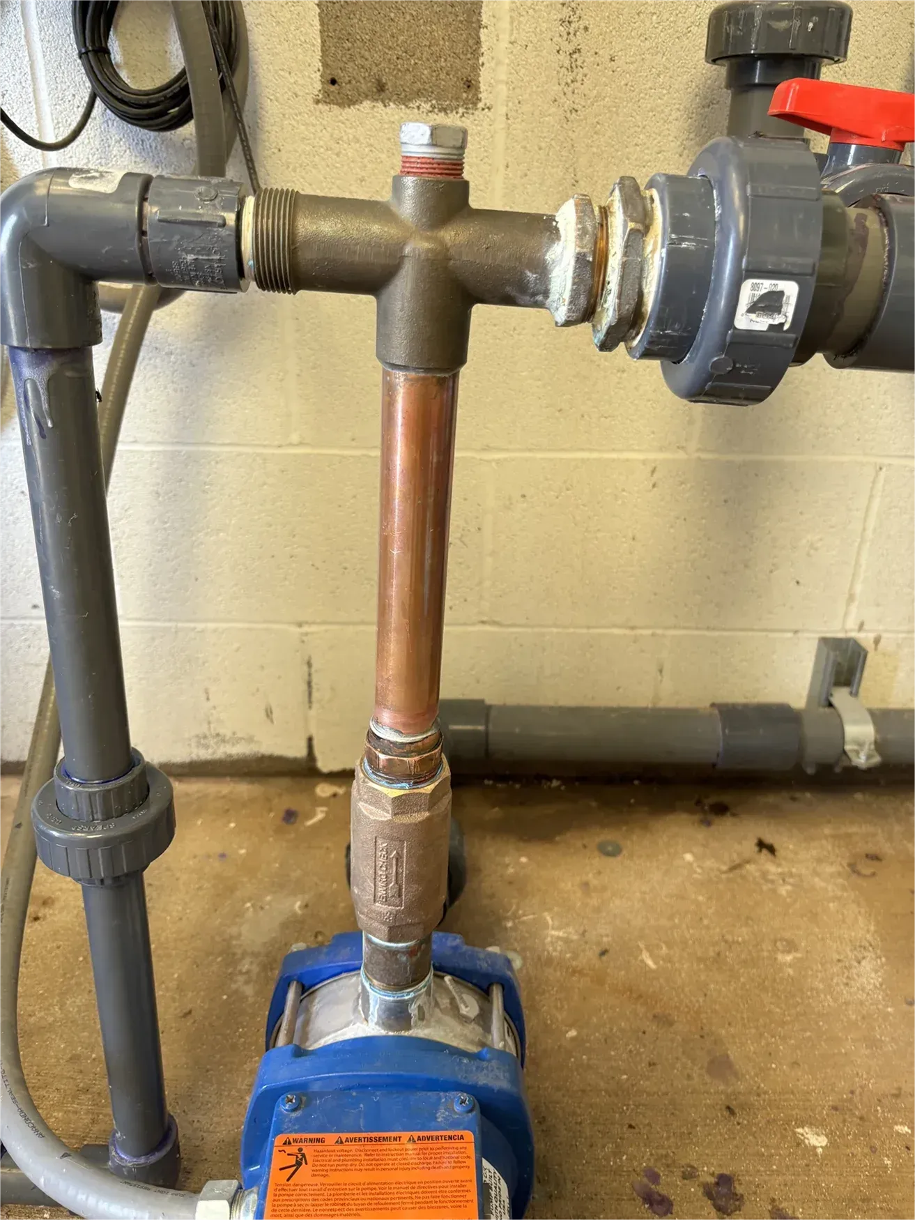 A close up of a copper pipe with a valve attached to it