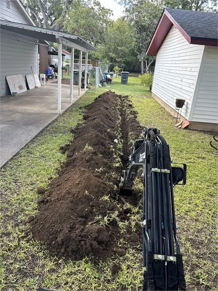 A large pile of dirt is sitting in front of a house.