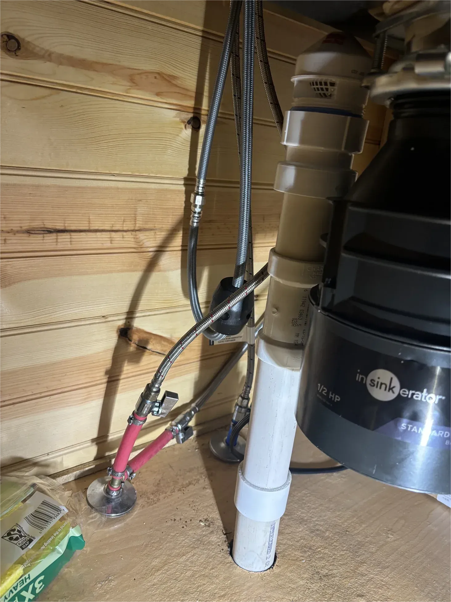 A garbage disposal is sitting under a sink in a kitchen.