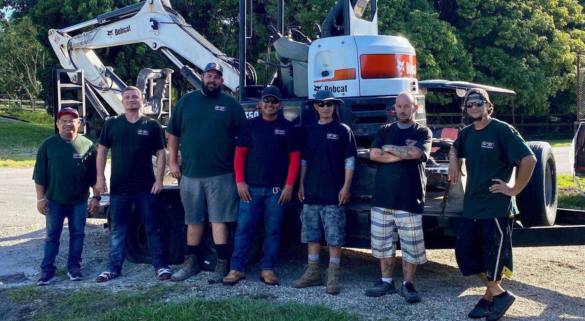 An excavator is loading dirt into its bucket at a construction site.