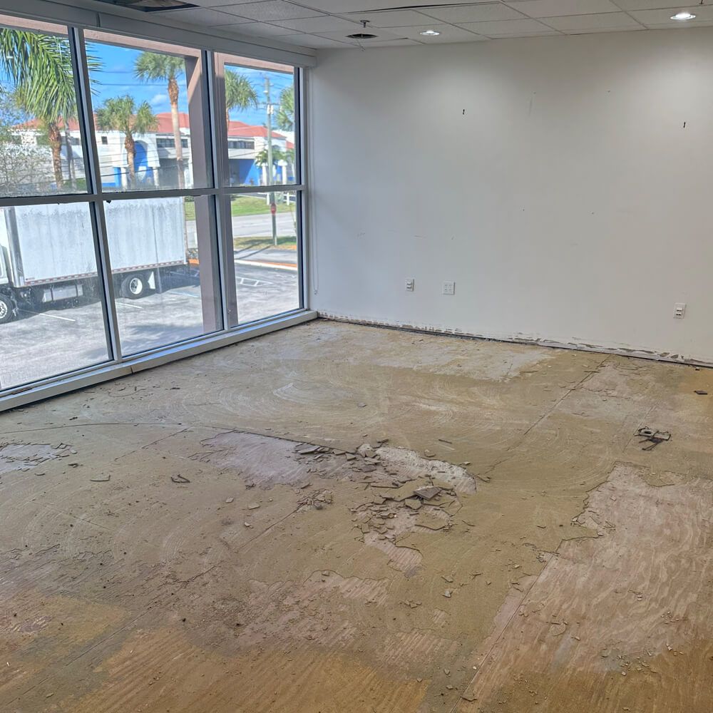 A construction worker is standing in front of a bulldozer on a construction site.