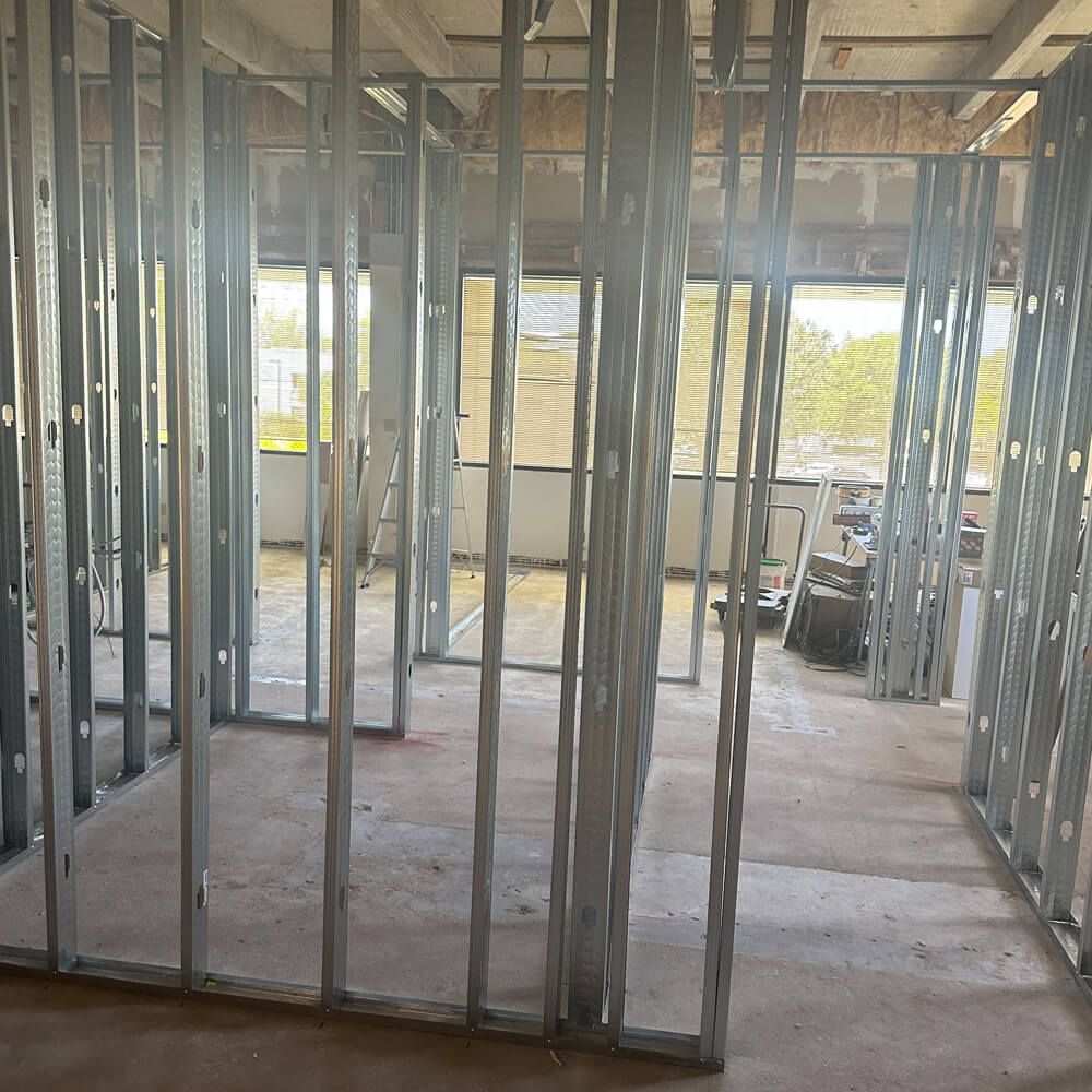 A couple of men are working on a wooden structure.