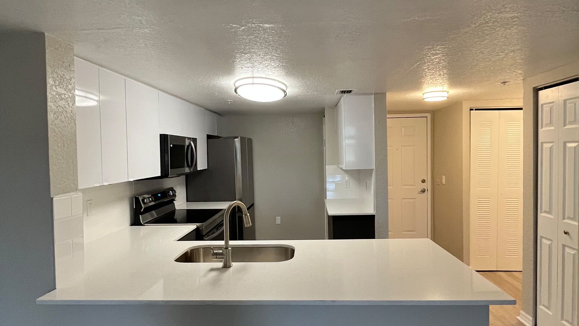 A yellow excavator is digging a hole at a construction site.