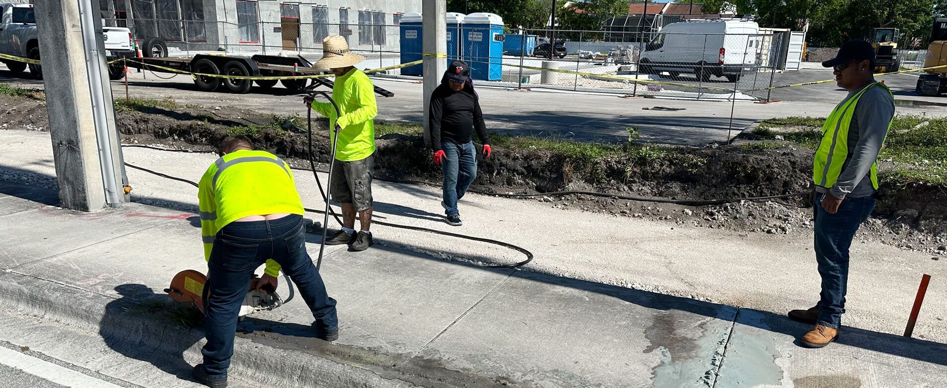 An excavator is loading dirt into its bucket at a construction site.