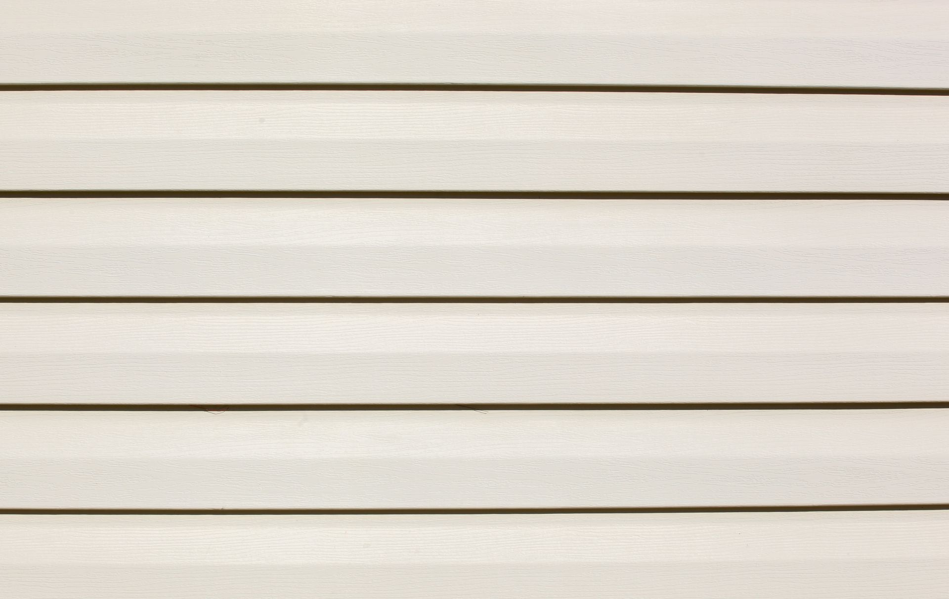 A close up of a white vinyl siding on a house.