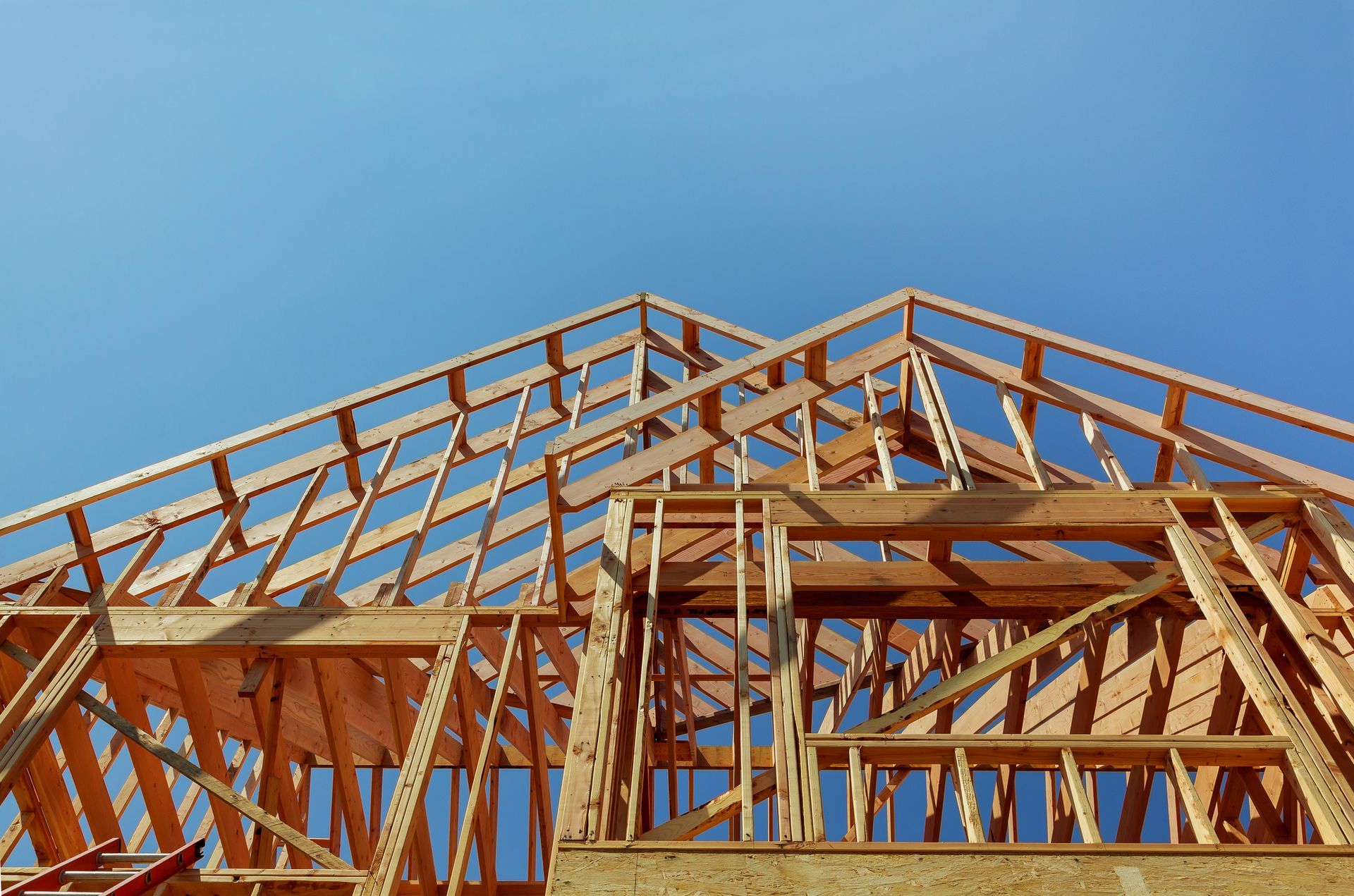 A house is being built with a blue sky in the background.
