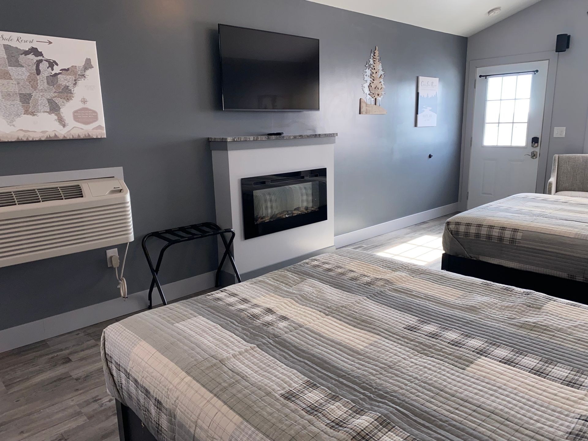 Two Queen Beds, TV, and electric fireplace in Cabin 5 at Creek Side Resort