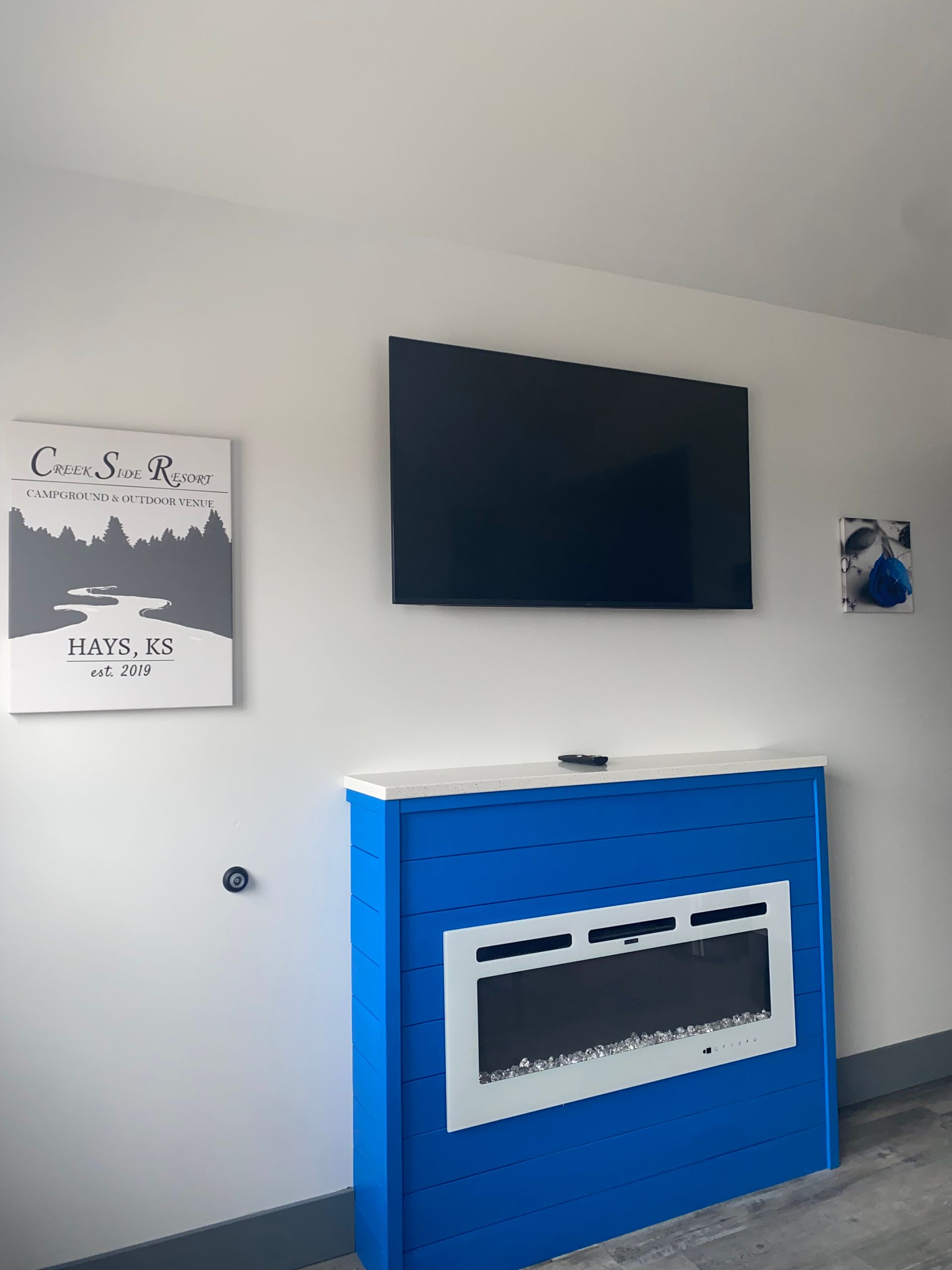 Living Room area with TV and electric fireplace in Cabin 9 at Creek Side Resort
