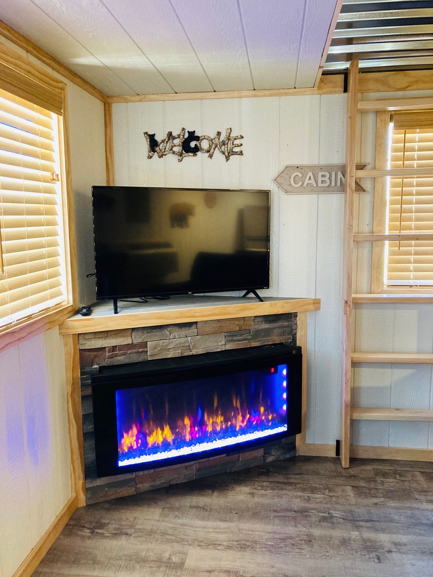 TV and electric fireplace in Luxury Lofted Cabins at Creek Side Resort
