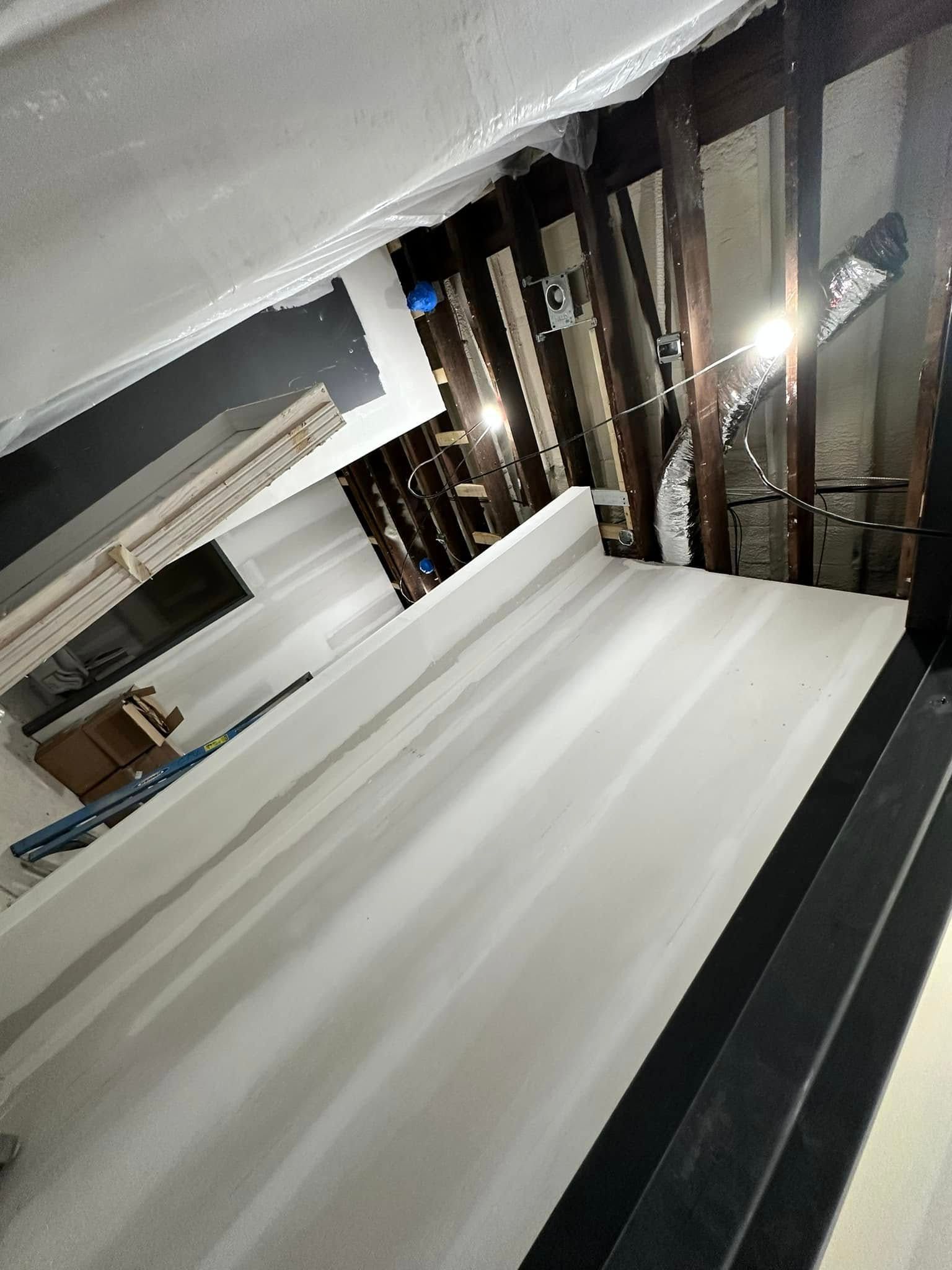 A room with a lot of windows and a ceiling that is being remodeled.