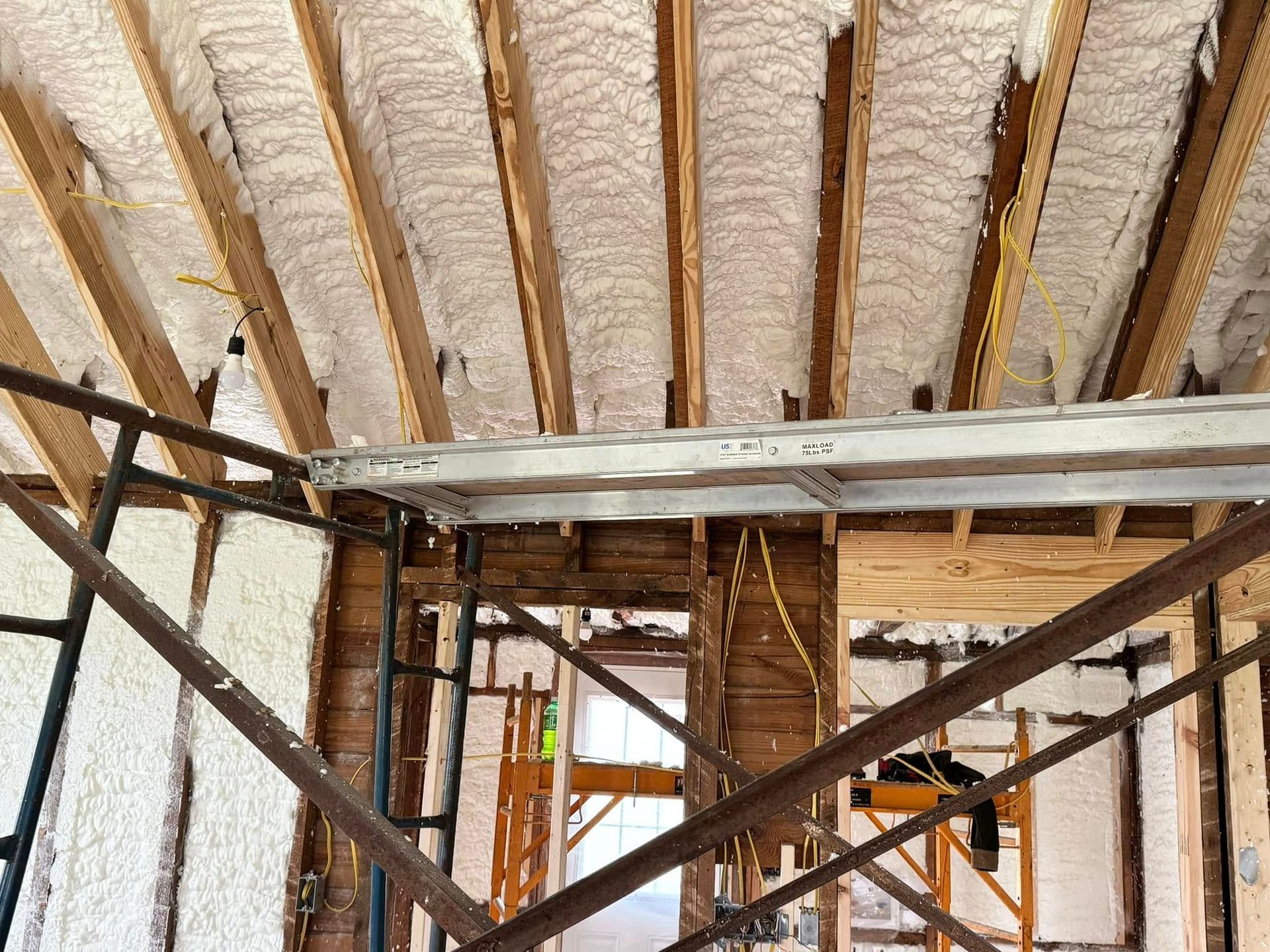 The ceiling of a building under construction with scaffolding.