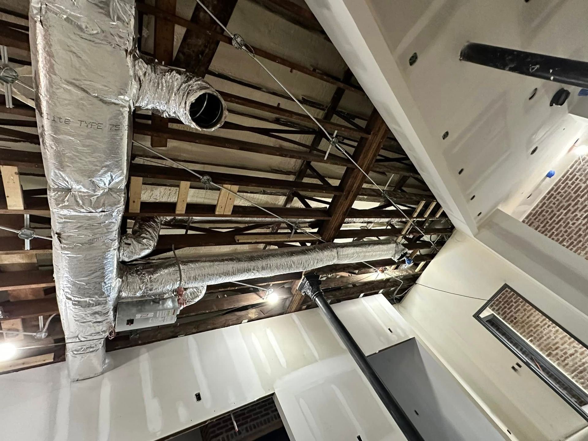 A ceiling with a lot of pipes hanging from it