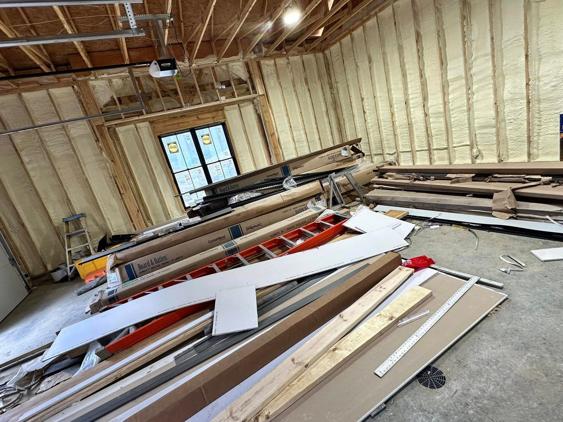 A room with a lot of wood and a ladder in it.