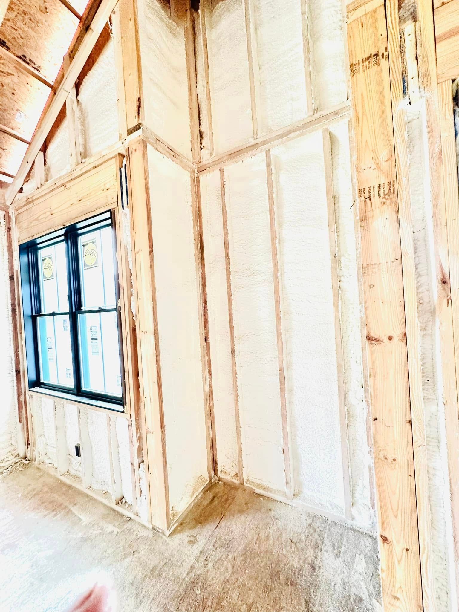 A room with a lot of wooden walls and a window.