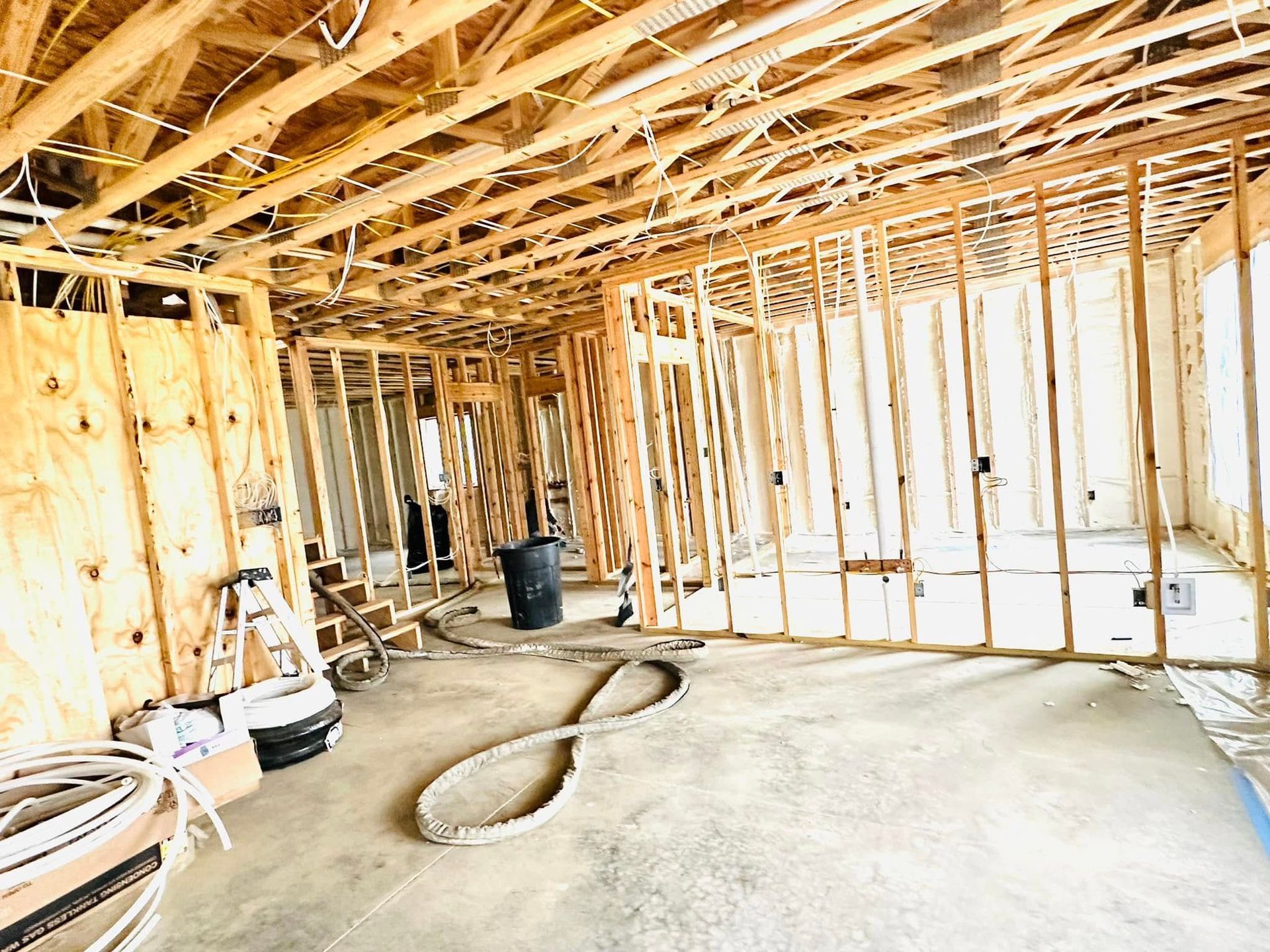 A room under construction with a lot of wooden beams.