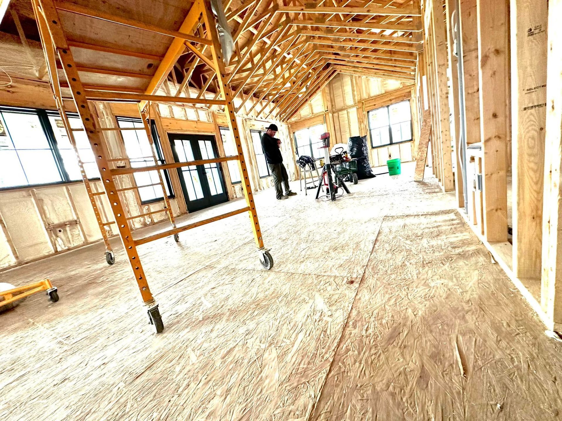 A man is standing in the middle of a building under construction.