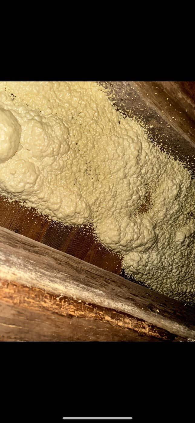 A pile of flour is sitting on top of a wooden table.
