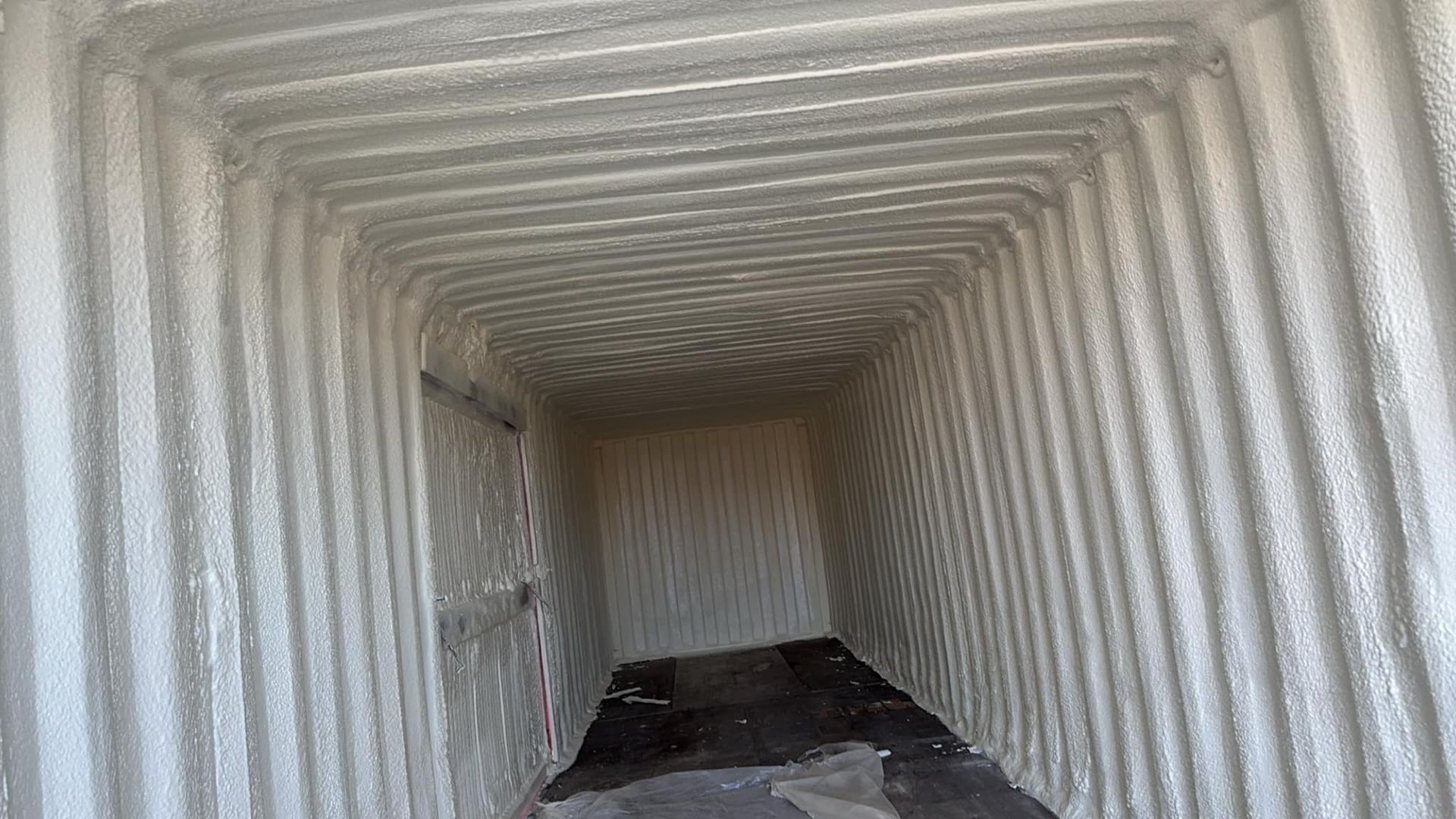 The inside of a shipping container is covered in foam.