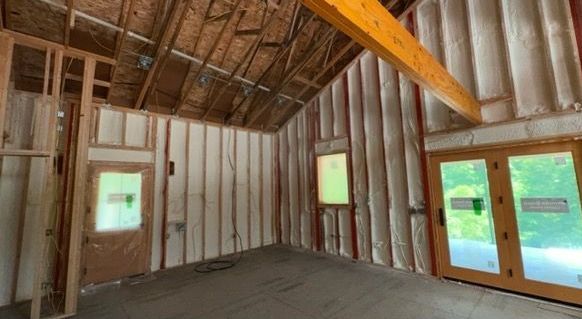 An empty room with a lot of insulation on the walls and ceiling.