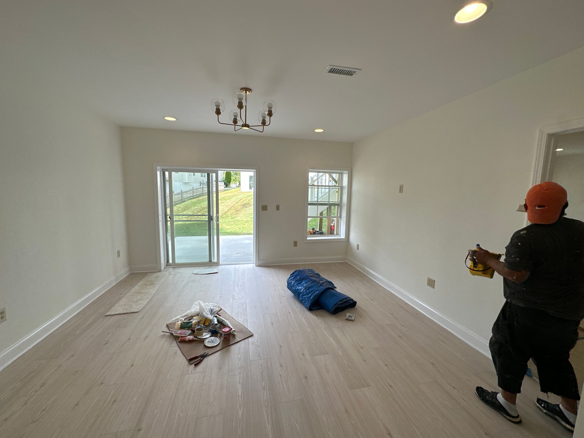 A man is standing in an empty living room.