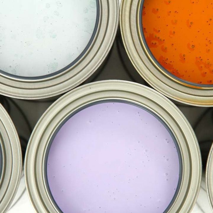 Several cans of paint are stacked on top of each other