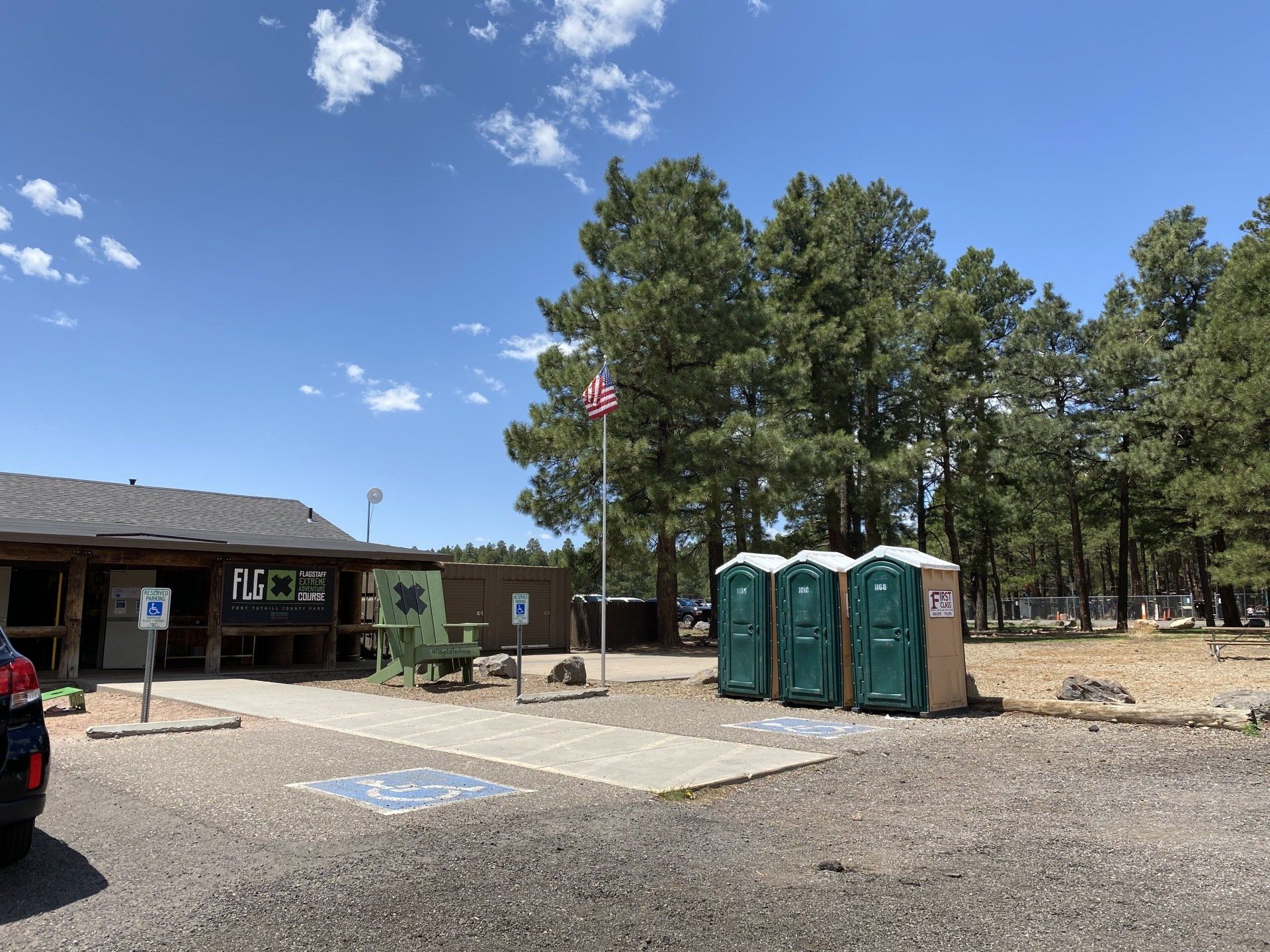 Portable restrooms near a flag | Flagstaff, AZ | First Class Sanitation