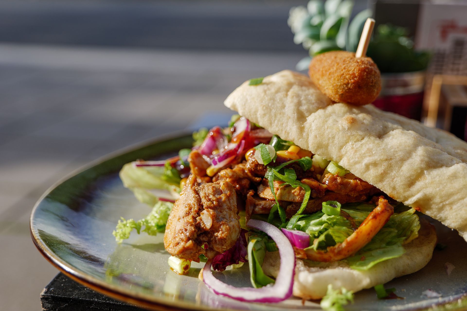 A close up of a sandwich on a plate on a table.