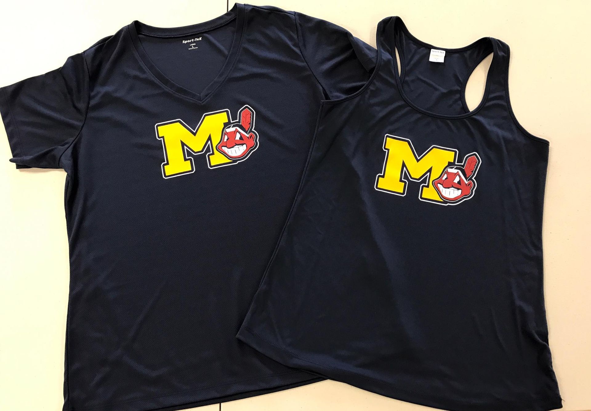 Two black shirts with the letter m on them